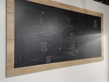 a blackboard on the wall in a room