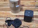 an image of a table with a speaker and a box on it