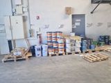 a room with a lot of boxes and pallets in it