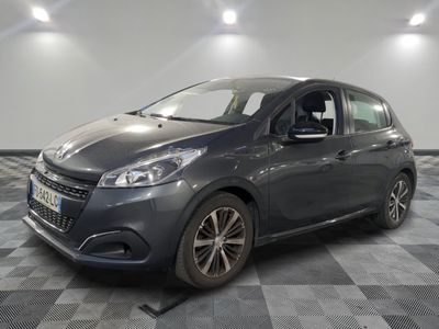 the grey car is parked on a checkered floor in the garage