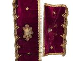 two pieces of red velvet with gold stars on them