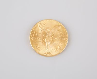 a close up of a gold coin on a white surface