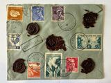 a piece of paper with stamps on it and a wax seal on it