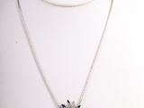silver necklace with black and white stones on a white mannequin