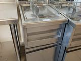 two deep fryers sitting on the counter in the kitchen