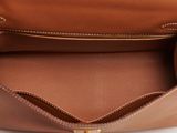 the inside of a brown leather purse with a gold zipper