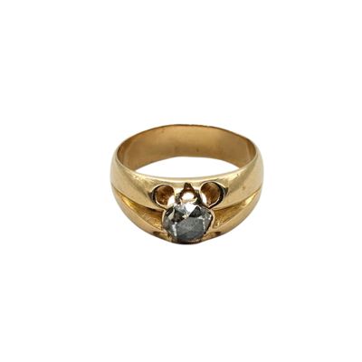 a close up of a gold ring with a stone in the middle
