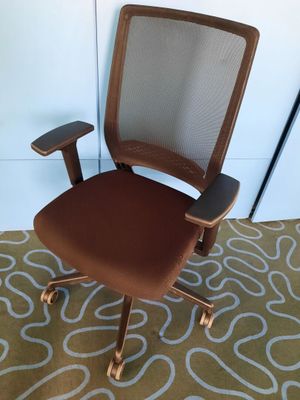 an image of a brown office chair on a rug in a room