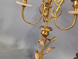 a gold candelab with three candles on top of it