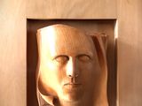 a picture of a wooden sculpture of a man ' s face