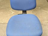 an image of a blue office chair sitting in a garage