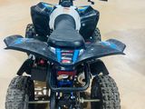 an image of a blue and black four wheeler atv