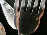 a fork and two spoons on a black surface