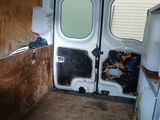 a white van with a broken door in a room