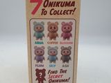 a box of 7 mini figurines of different colors
