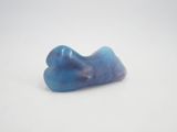 a close up of a blue stone on a white surface