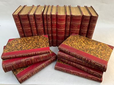six red books stacked on top of each other on a white surface