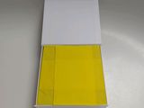 a white box with a yellow lid sitting on top of a table