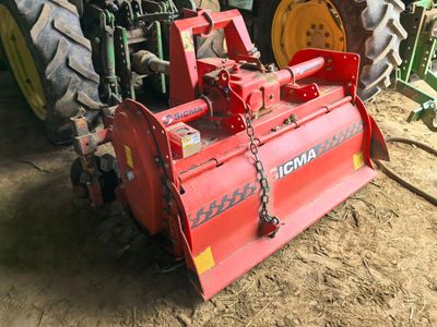 a tractor with a plow attached to it in the dirt
