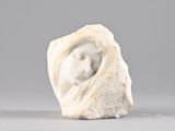 a white sculpture of a woman in a shell on a table