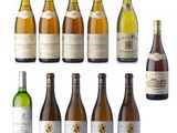 several bottles of wine are lined up on a white surface