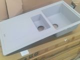 a white plastic sink sitting on top of a cardboard box