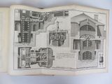 an open book with a drawing of a building and a drawing of a church
