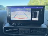 a car dashboard with a basketball game on the screen