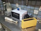 a microwave and toaster sitting on a counter in a kitchen