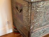 an old trunk sitting on a wooden floor