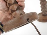a person that is holding a wooden object in their hand