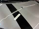 a sticker on the hood of a car that is parked in a garage