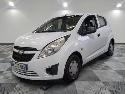 a picture of a small white car parked on a checkered floor