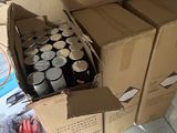 many cans of soda sitting in a box on the floor