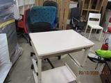 a white table with a blue chair in the middle of a room