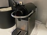 a coffee maker on a counter next to a cup holder