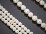 three strand pearl necklace with a gold clasp