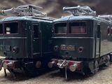 two trains that are sitting side by side on a table