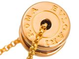 a close up of a gold plated clock on a chain