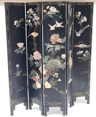 an image of a black room divider with flowers and birds on it