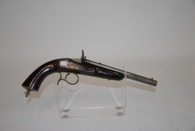 an old gun on a clear stand on a white surface