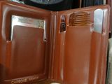a person holding a brown wallet with a wallet inside of it