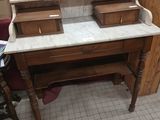 a marble top desk with two drawers and a mirror