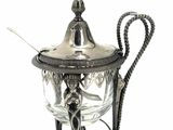 an antique silver teapot with a handle on a white background