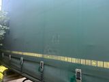 a green train car that is parked on the tracks