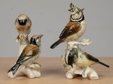 three figurines of birds sitting on top of each other
