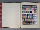 an open book with stamps on it sitting on a table