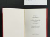 an open book with a handwritten note on it sitting on a table