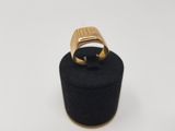 a close up of a gold ring on a black ring holder