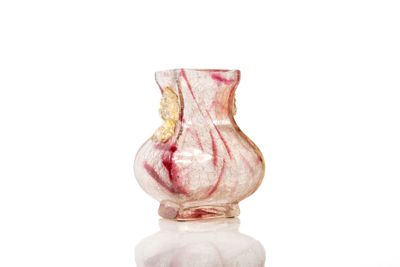 a glass vase that is sitting on top of a marble table